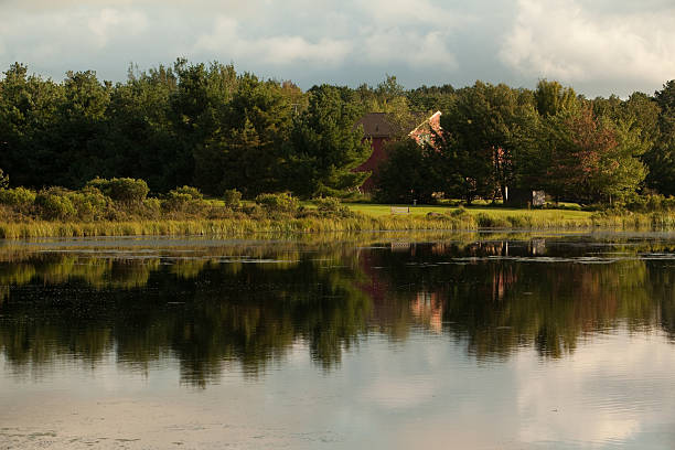 istock Country hous in the forest, on lake, with reflections 176095321