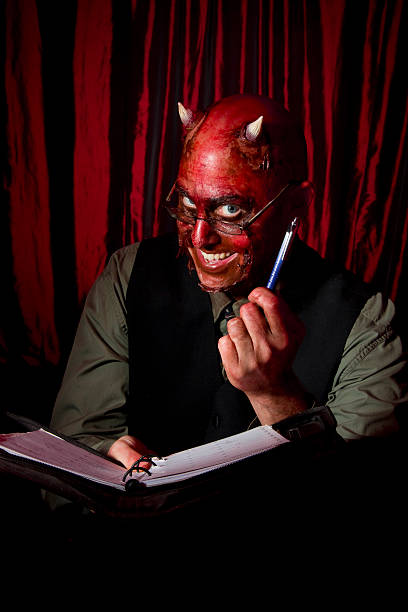 Devil with a contract stock photo