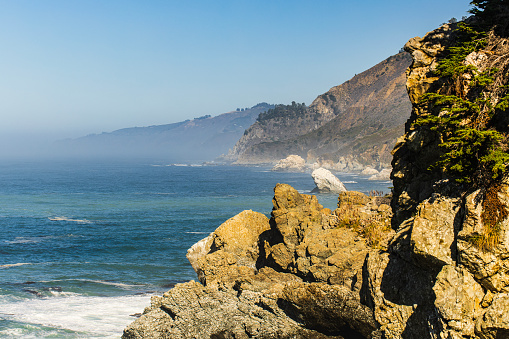 Coastal scene of Big Sur State park on a warm sunny morning with light rays, California.