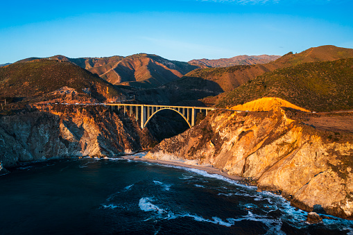Aerial shot of Bixby bridge in Big Sur State park coast on a sunny afternoon, California.