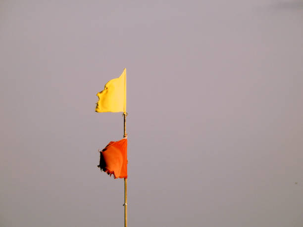istock Yellow and red flags on the beach, beach warning flag system, red flag means High risk, rough conditions, strong surf, and currents, Yellow flag means Medium risk, light surf currents, lifeguard 1760963056