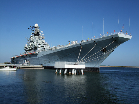 American aircraft carrier anchored in a harbour after offshore training exercises.