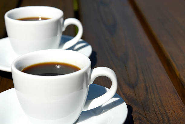 istock Two white cups of espresso on a wooden table 176096928
