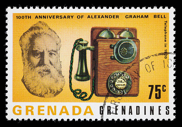Bell and 1920 telephone postage stamp 1977 Grenada postage stamp with images of Alexander Graham Bell and a 1920 telephone. DSLR with macro lens; no sharpening. alexander graham bell stock pictures, royalty-free photos & images