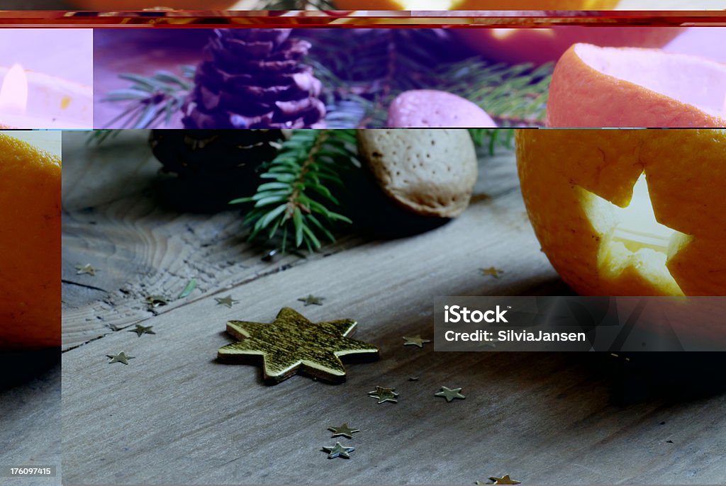 traditional orange chrismas decoration traditional chrismas decoration such as orange halves with star shaped holes, golden star,fir branch and pine cone on wooden background Almond Stock Photo