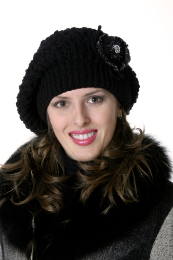 The girl in the warm woolen cap and the coat with neck-piece.