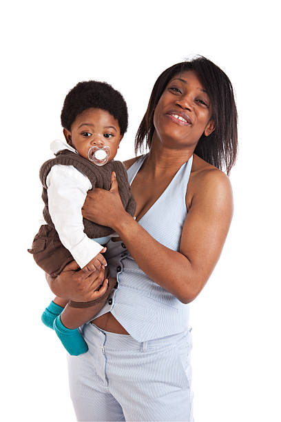 Mother and her  6 months old son on white background and smiling