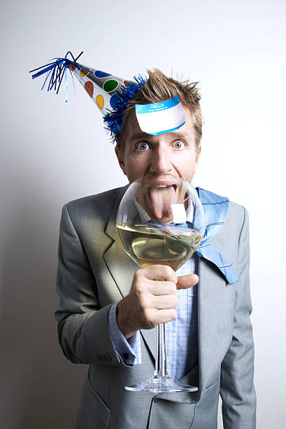 istock Office Worker Businessman with Party Hat Drinking from Big Glass 176098993