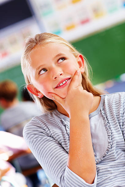 istock Schoolgirl day dreaming in a class and looking away 176099111