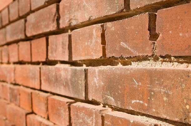 Ljubljana, Slovenia – July 14, 2025: Close-up of a weathered stone wall above a window frame in Ljubljana, Slovenia, showing the texture and layers of old masonry construction.