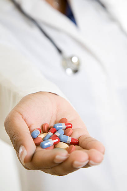 istock Physician Holding Out Handful of Various Pills 176100031
