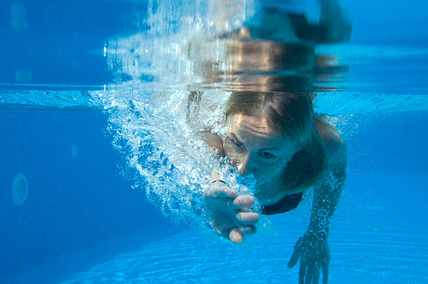 istock Young woman swimming in pool 176100248
