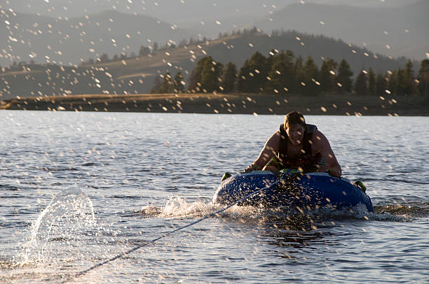         Teenager at the wheel of a ski boat.                       