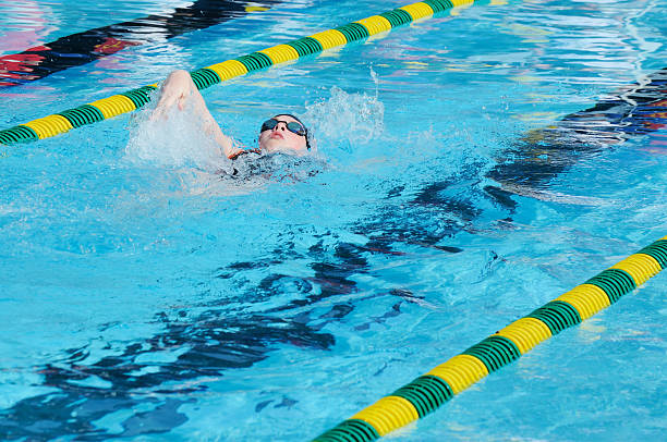 istock Young Girl Athlete Backstroke Swimmer Racing in Pool 176100696