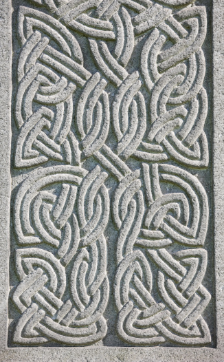Celtic Knotwork decoration on a grey granite gravestone.