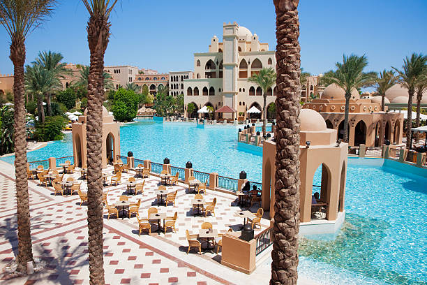 Beautiful Luxury Tourist Resort Hotel "Luxury hotel tourist resort with restaurants, arabian style apartments, large swimming pool, pool bar, sun loungers, palm trees and small pavillions in summer." Hurghada stock pictures, royalty-free photos & images