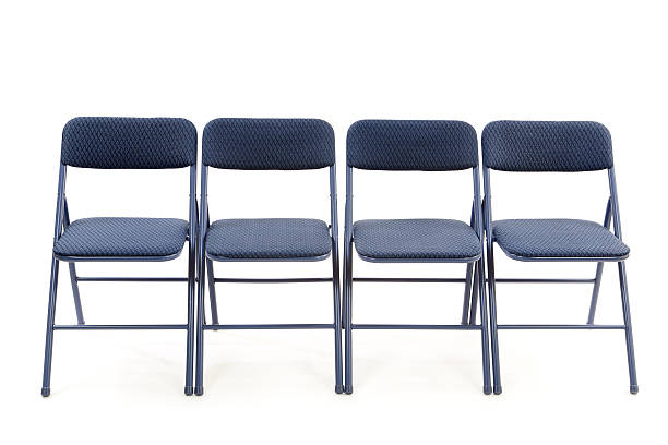 Row of Folding Chairs Row of four folding chairs isolated on white.Please also see: folding chair stock pictures, royalty-free photos & images