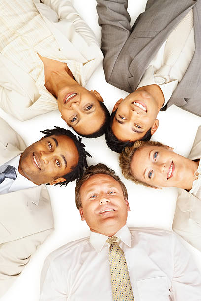istock Happy business colleagues lying on white background 176101802