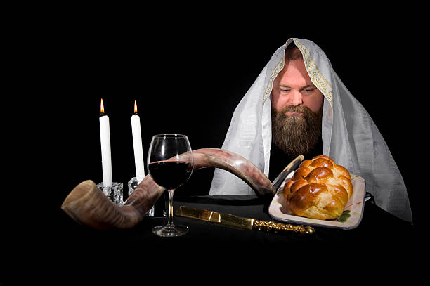 Jewish Rabbi Wearing Tallit Looking at Challah stock photo