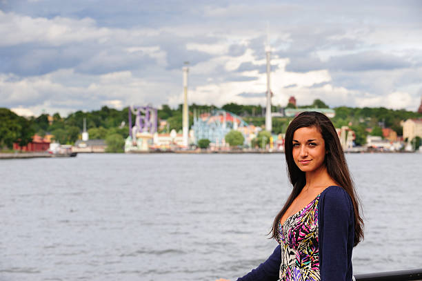 istock Woman smiling, amusement park in the background 176101990