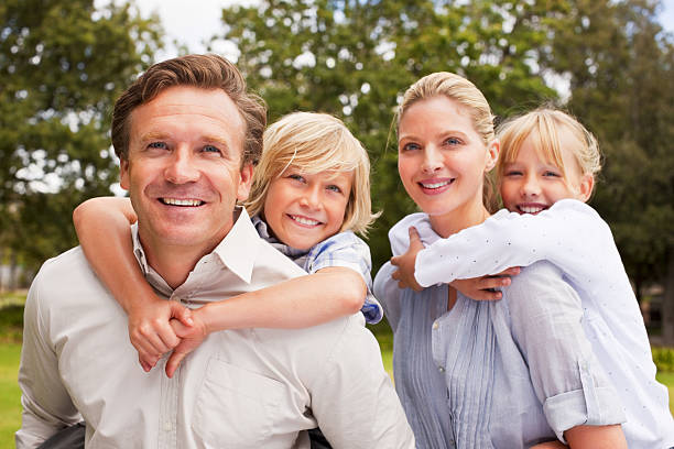 istock Happy parents piggybacking their children 176102206