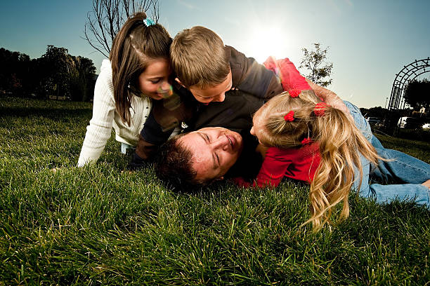 istock Father and Three Kids Wrestling 176102952