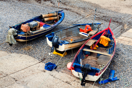 Fishing boats pulled up onto a slipway on  Sheringham beach in Norfolk, England.