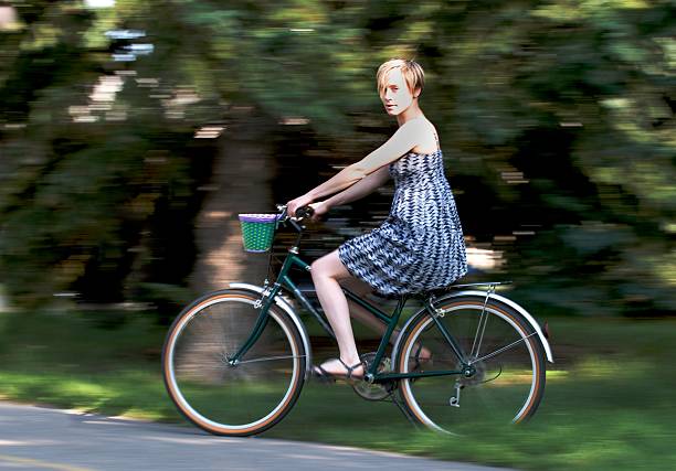 istock Pretty Girl Riding Bycycle - Motion Blur 176104367