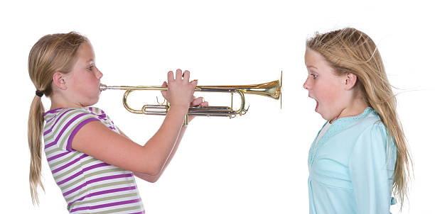 Trumpet Blow A trumpet player blowing loudly. hair band stock pictures, royalty-free photos & images