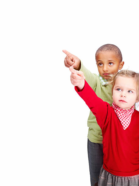 istock Little boy and girl pointing away 176104873