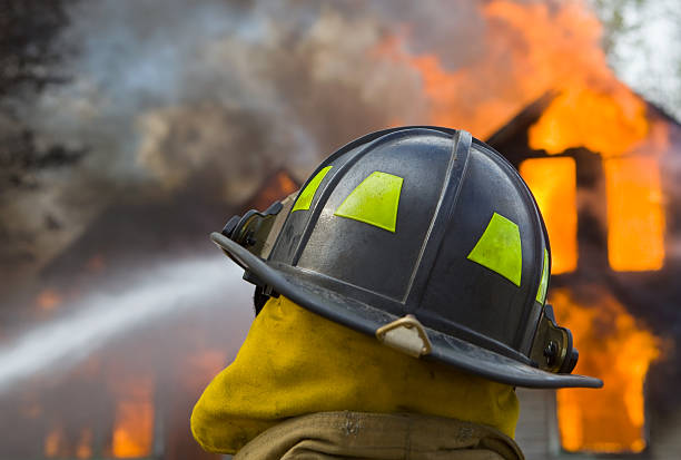 istock Firefighter in front of a House Fire 176106097