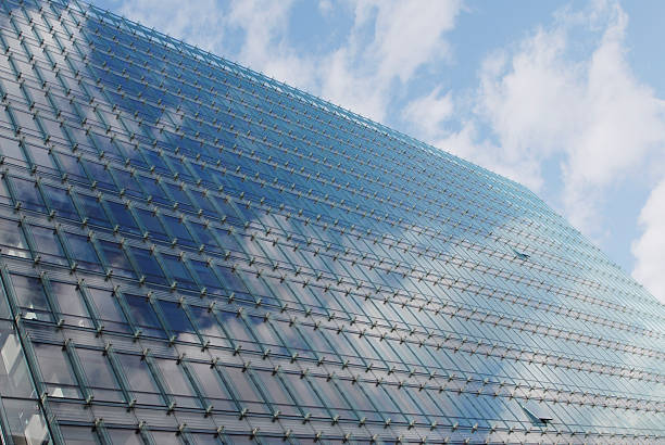 istock Modern glass office building reflecting a blue sky 176106282
