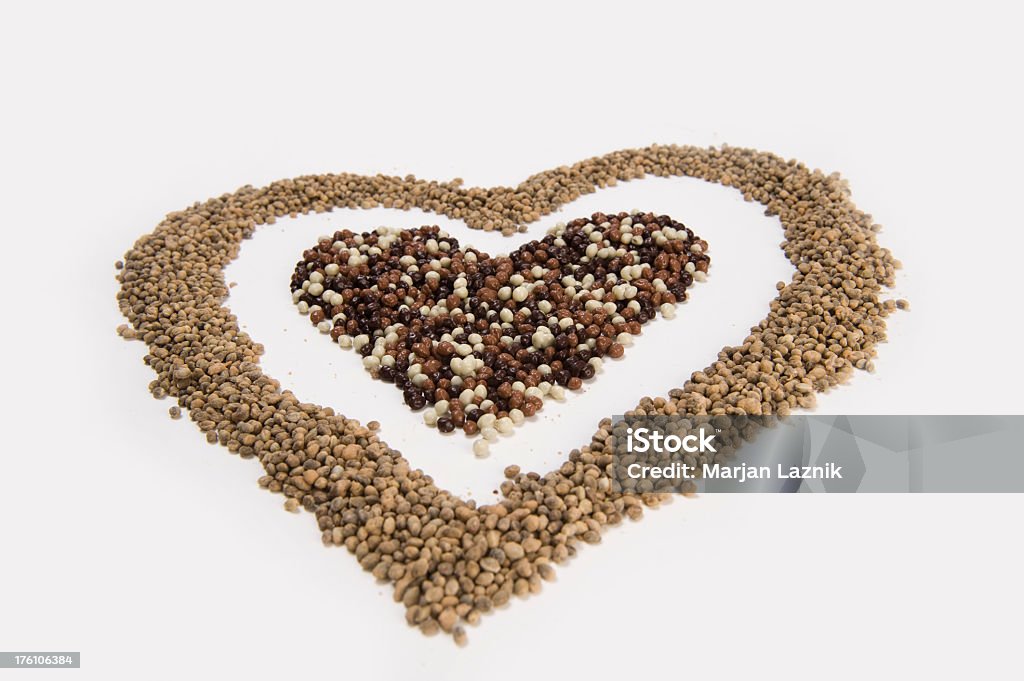 Heart of thousands seeds Hemp seed in the form of heart. With love. Heart Shape. An heart maked with various seeds.  Food Stock Photo