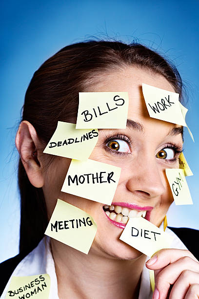 istock Multitasking woman bites adhesive note labeled DIET; she's losing control! 176108092