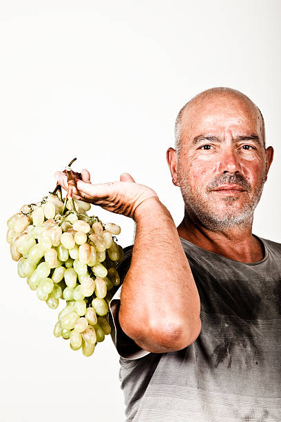Man holding a bunch of grapes