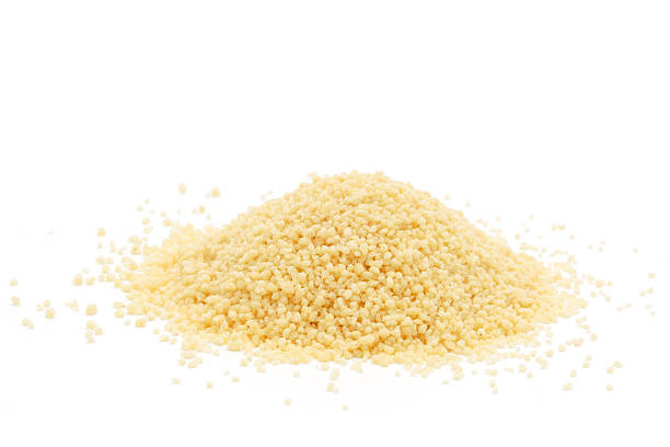 Pile of Couscous A pile of raw cous cous isolated on white. couscous stock pictures, royalty-free photos & images