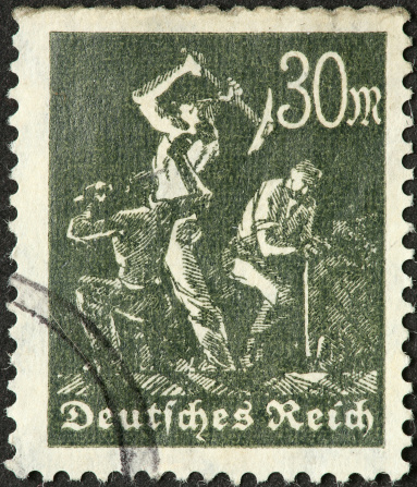 old German stamp with three toiling miners.