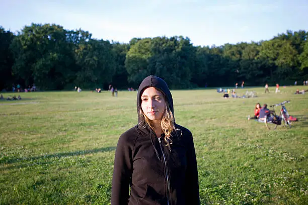 Photo of Attractive Blonde Young Woman wearing a Black Hoody in Park