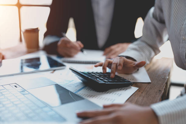 istock Business people in a meeting and using a calculator to calculate, plan, analyze, create graphs and charts to show business growth to plan new business expansions in the future. 1761099688
