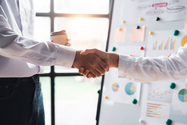 Business people shaking hands during a meeting.