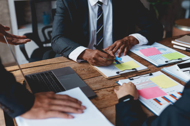 istock Groups of business people meeting to plan work with laptop computers, analyze graphs and corporate growth charts to plan future business expansions. 1761107932