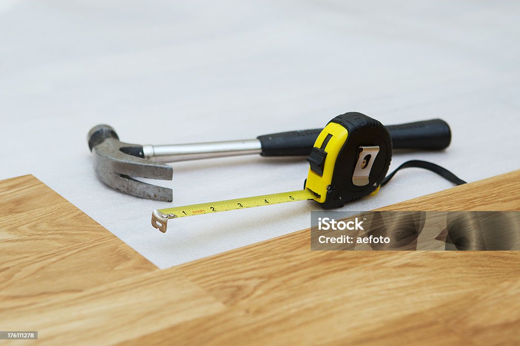 Installing wooden floor Installing a wooden floor (oak). Focus is on the measuring tape.Same series: Claw Hammer Stock Photo