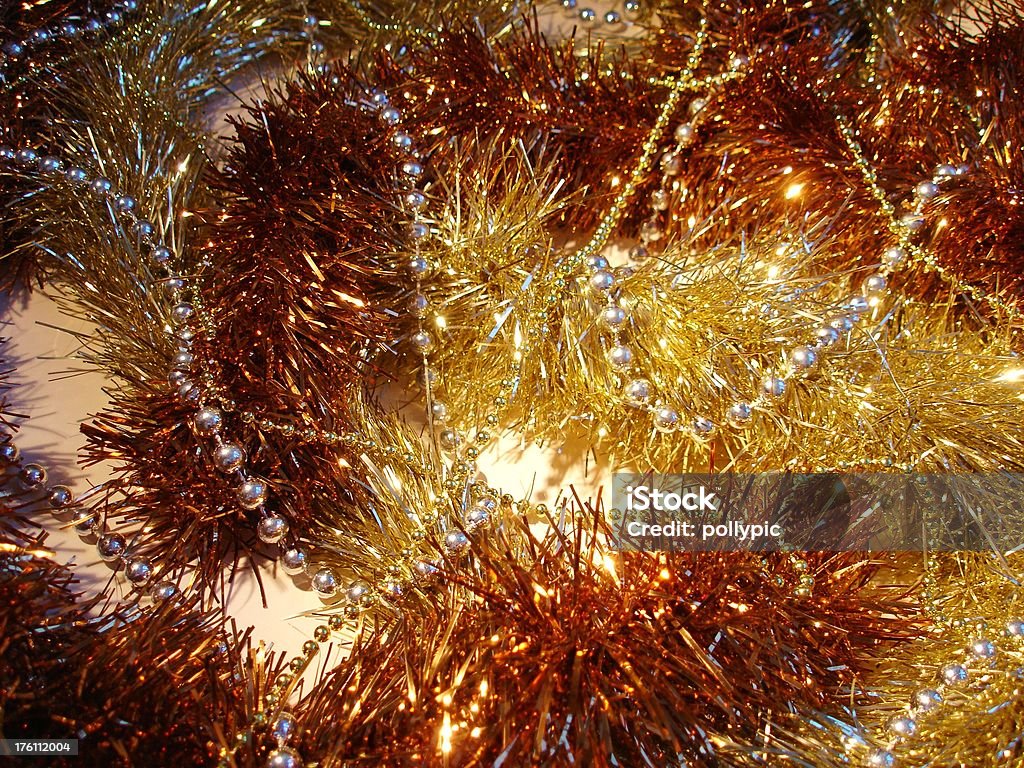 Christmas Gold theme Babbles and tinsel set against a cream coloured card for a Gold Christmas theme. Suitable for backgroud. Bead Stock Photo