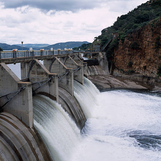 istock Water flowing through a dam with a bridge above 176113564