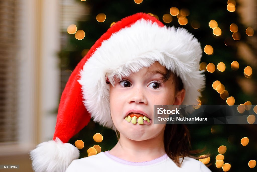 little christmas grinch A little girl with fake teeth looking surprised.  Acting the part of the grinch. Celebration Event Stock Photo
