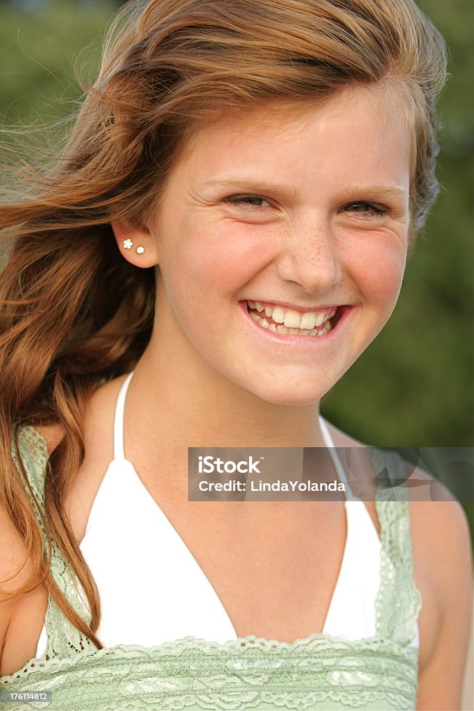 Girl in the Wind A portrait of a happy thirteen year old girl at the beach on a windy day. 12-13 Years Stock Photo