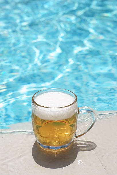 istock Glass of beer by the pool 176114849