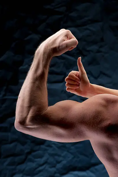 Photo of thumbs up for muscular arm curl