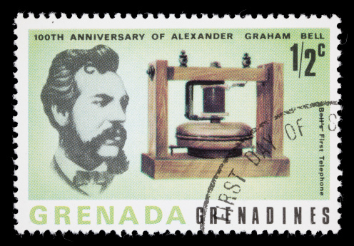 1977 Grenada postage stamp with images of Alexander Graham Bell and the first telephone created. DSLR with macro lens; no sharpening.