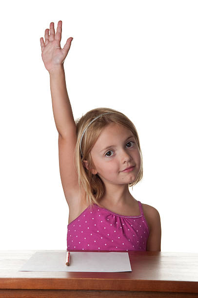 istock Young girl at a desk, hand raised. 176115483